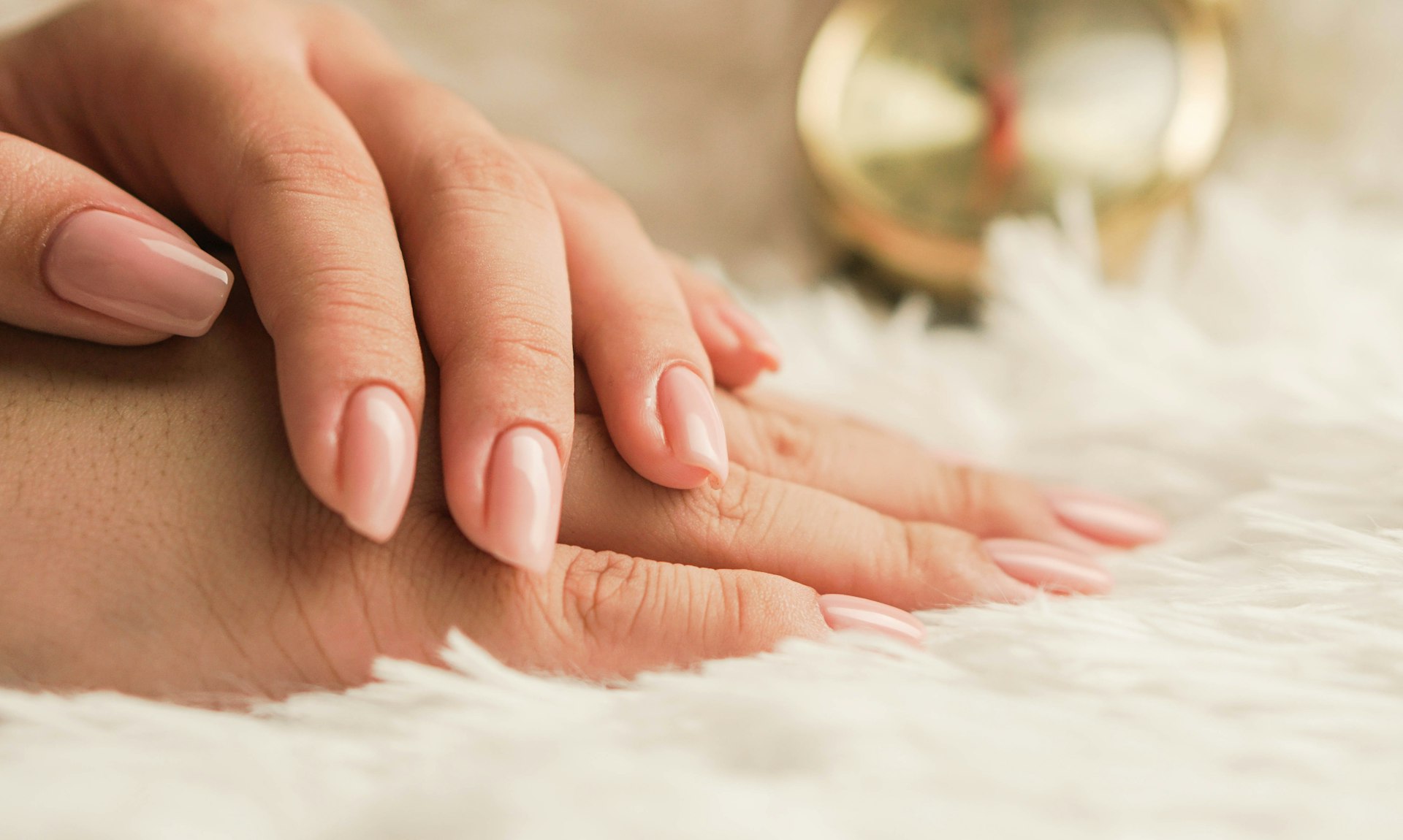Softly manicured hands with a natural pink finish