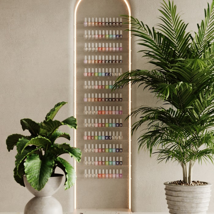 A floor-to-ceiling rack of gel colour samples framed by two potted palms