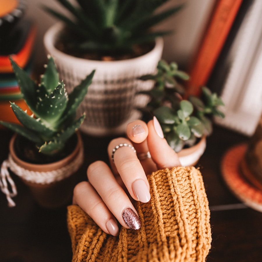 Soft nude manicure beside potted succulents on the studio shelf