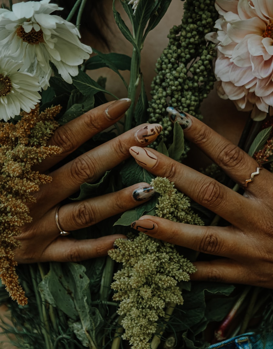 Warm neutral manicure holding a dried autumn bouquet