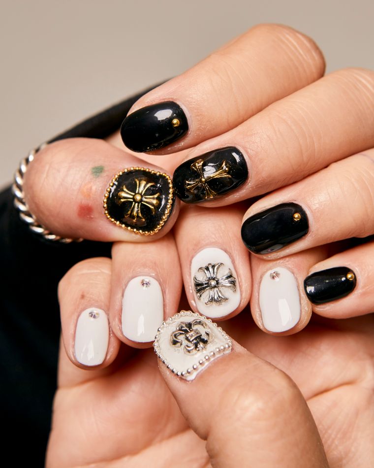 Nails hand-painted with black, white and gold ornament