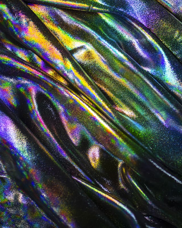 A close macro of crumpled metallic foil catching cold light